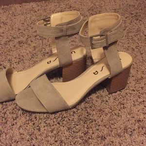 Tan/beige ankle buckle open toe heels.